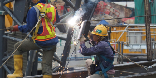 An image of a worker welding on site.